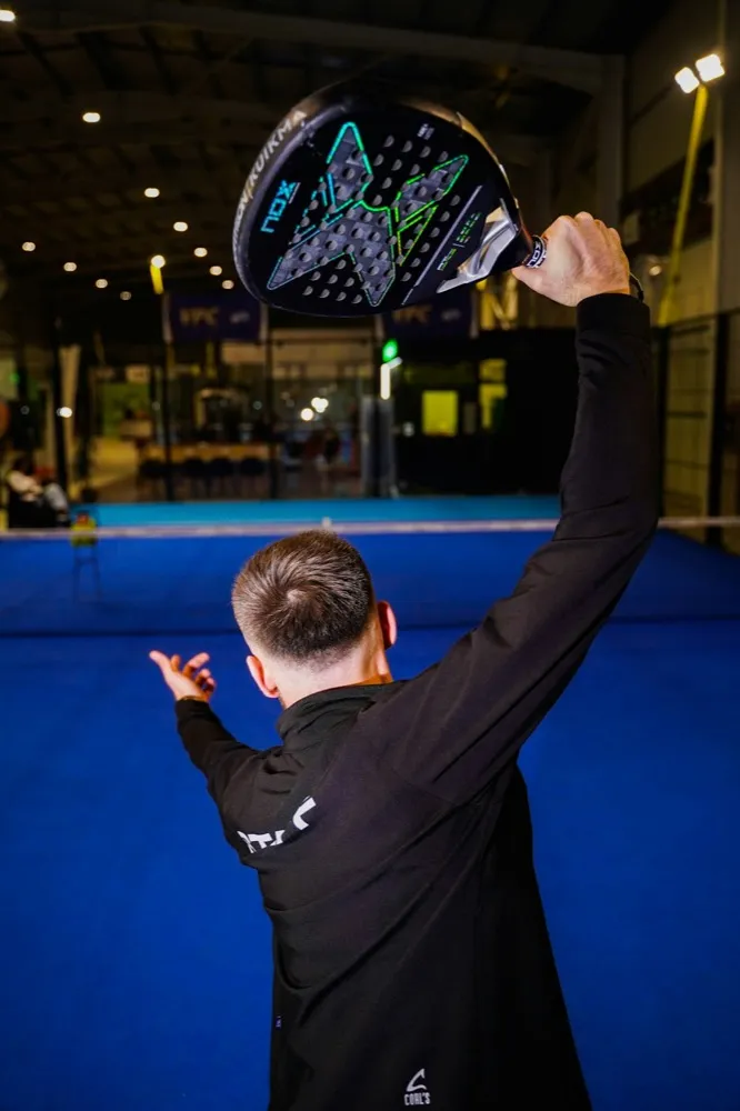 A player following through on an overhead smash